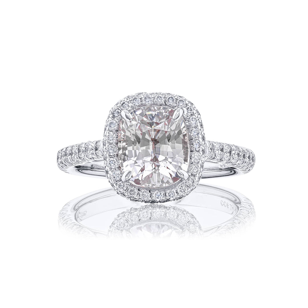 Breathtaking Radiance: Our exquisite 3.09 ct. certified White Sapphire Ring. This beautiful cushion-cut white sapphire cradled in micro pave diamonds is handcrafted in pure platinum.