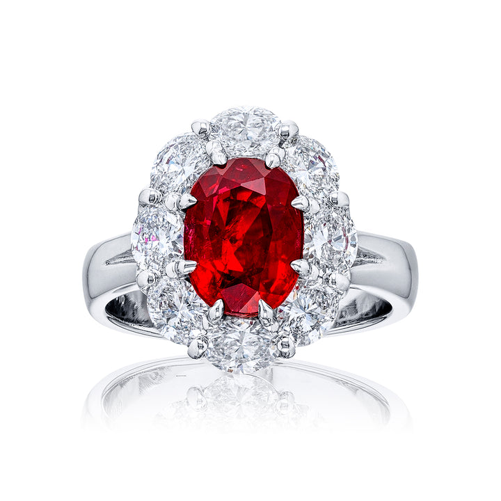 Stunning Ruby and diamond ring featuring a 3.13 ct. certified Burma oval-cut Ruby encircled by oval diamonds. Handcrafted in pure platinum.