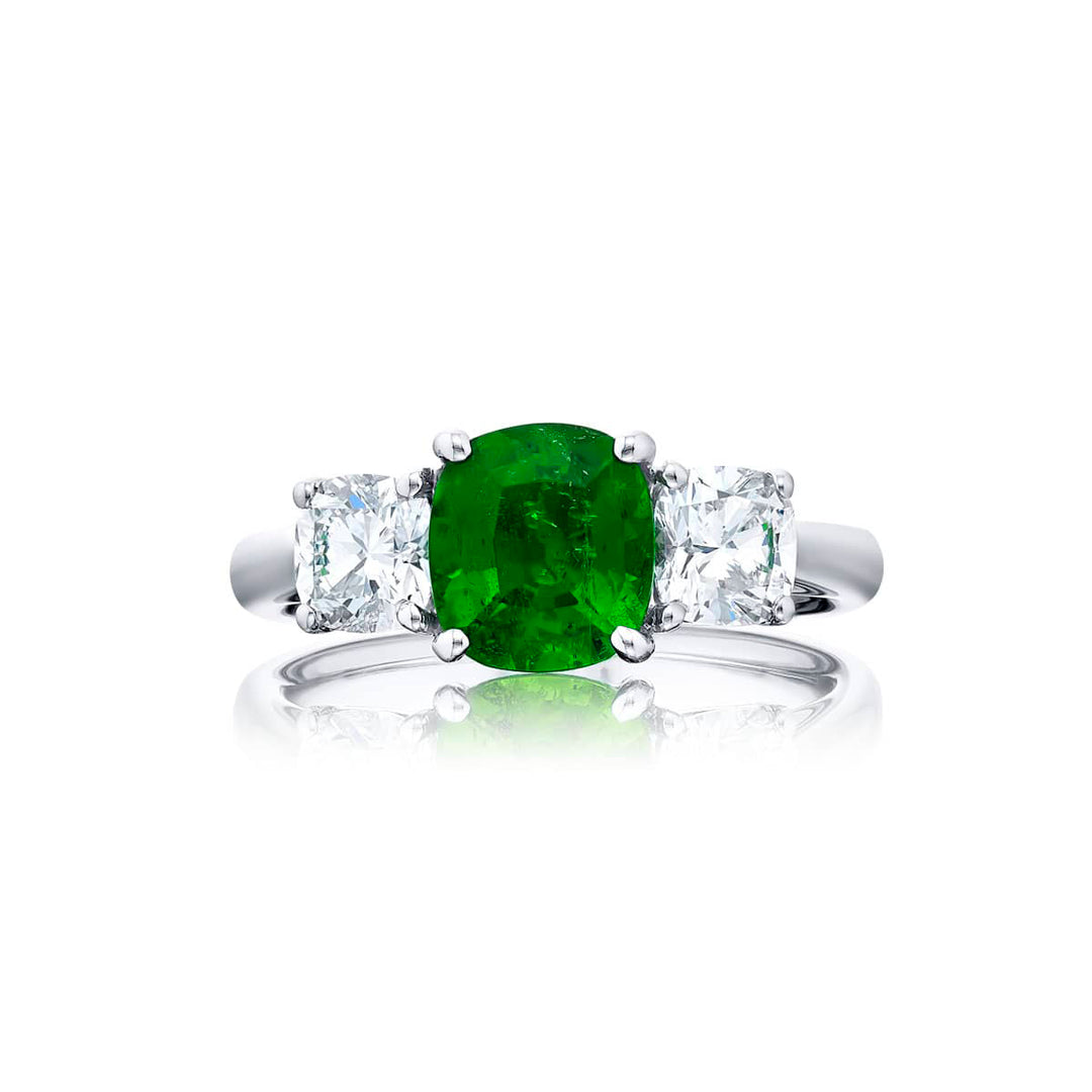 Breathtaking Radiance: Our stunning 1.33 ct. GIA certified Emerald Ring. This beautiful cushion-cut emerald flanked by cushion-cut diamonds is handcrafted in pure platinum.