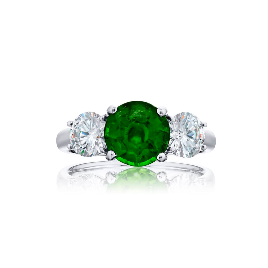 Breathtaking Radiance: Our stunning 2.01 ct. certified Vivid Emerald Ring. This beautiful round vivid emerald flanked by round diamonds is handcrafted in pure platinum.