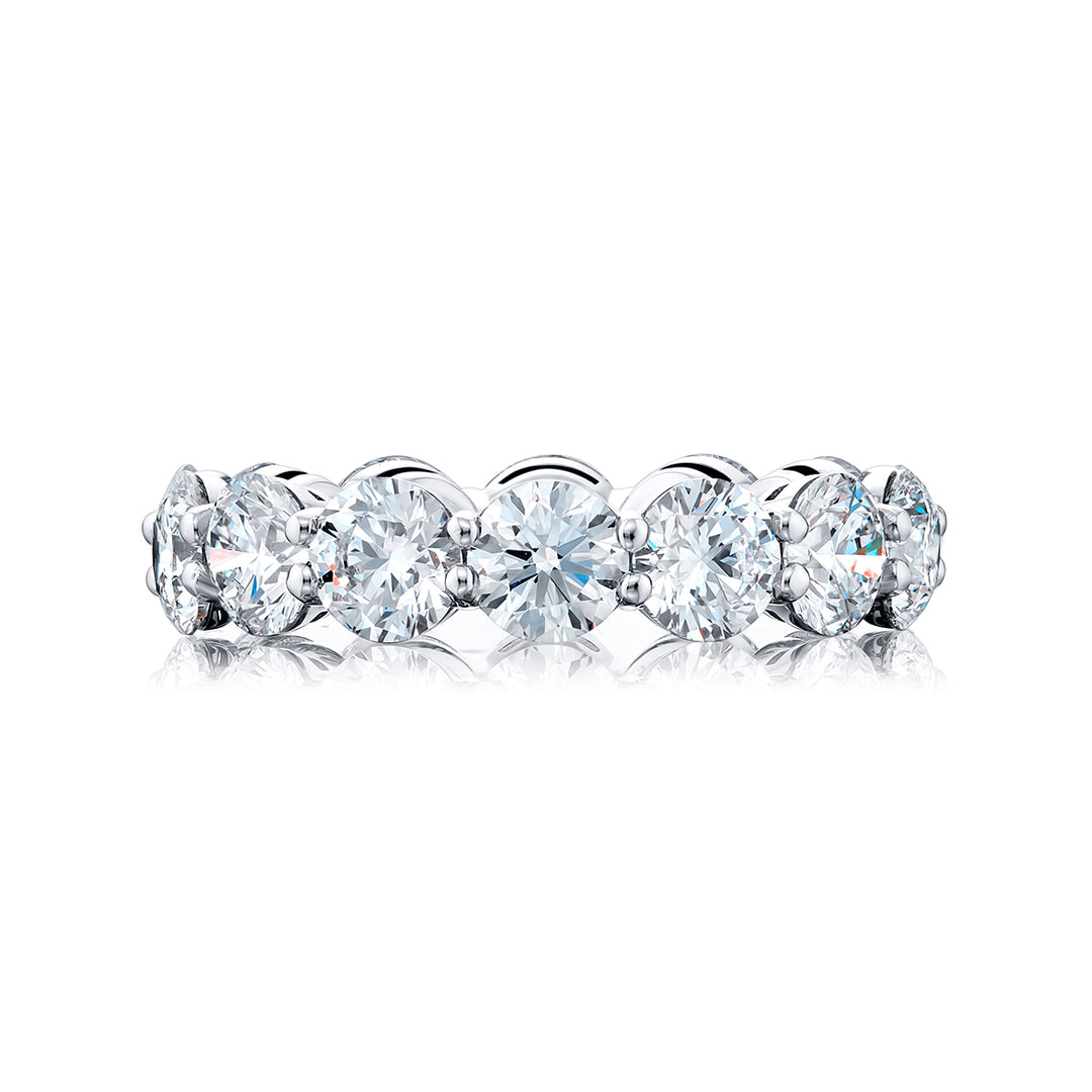 An exquisite eternity band meticulously handcrafted in pure platinum showcasing 14 round diamonds elegantly set within a shared prong arrangement exuding timeless allure.