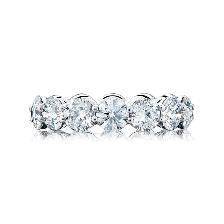 An exquisite eternity band meticulously handcrafted in pure platinum showcasing 14 round diamonds elegantly set within a shared prong arrangement exuding timeless allure.