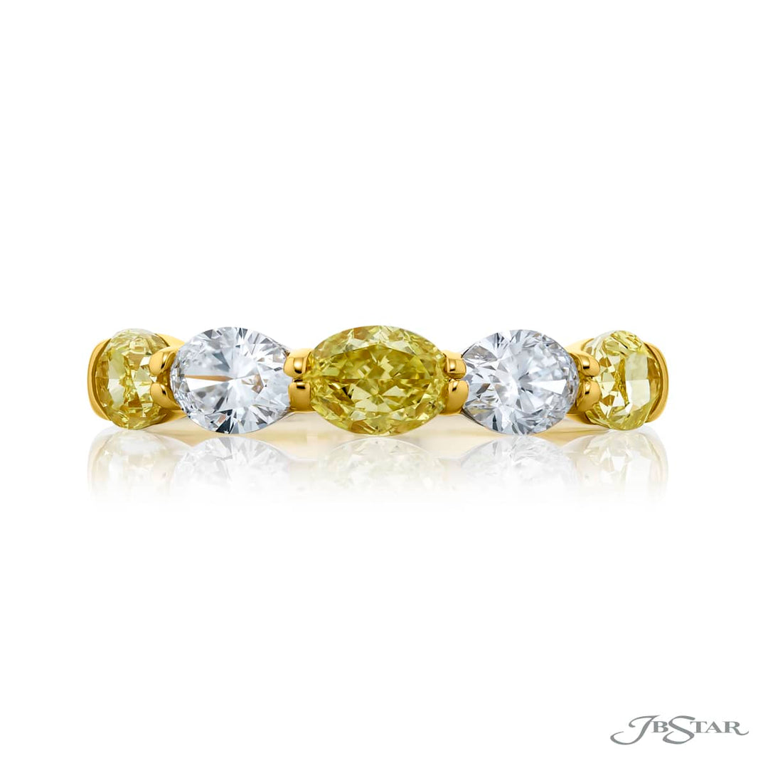 Elegance Elevated: Our classic single row East-West Fancy Yellow & White Diamond Band. These stunning oval fancy yellow diamonds accompany oval white diamonds and are handcrafted in 18KY gold.