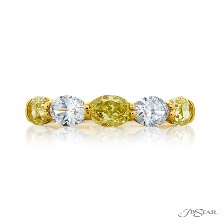 Elegance Elevated: Our classic single row East-West Fancy Yellow & White Diamond Band. These stunning oval fancy yellow diamonds accompany oval white diamonds and are handcrafted in 18KY gold.