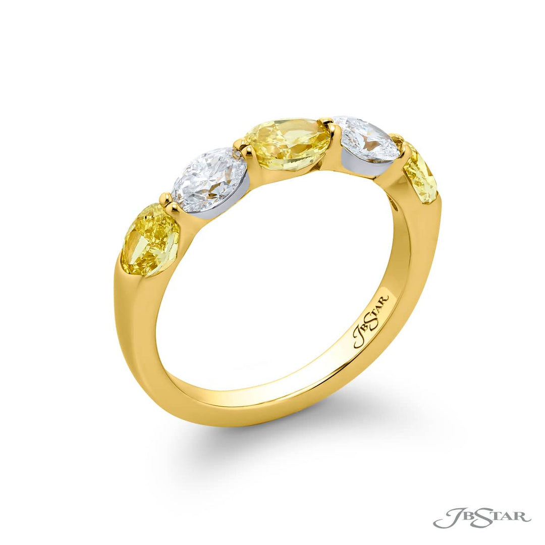 Elegance Elevated: Our classic single row East-West Fancy Yellow & White Diamond Band. These stunning oval fancy yellow diamonds accompany oval white diamonds and are handcrafted in 18KY gold.