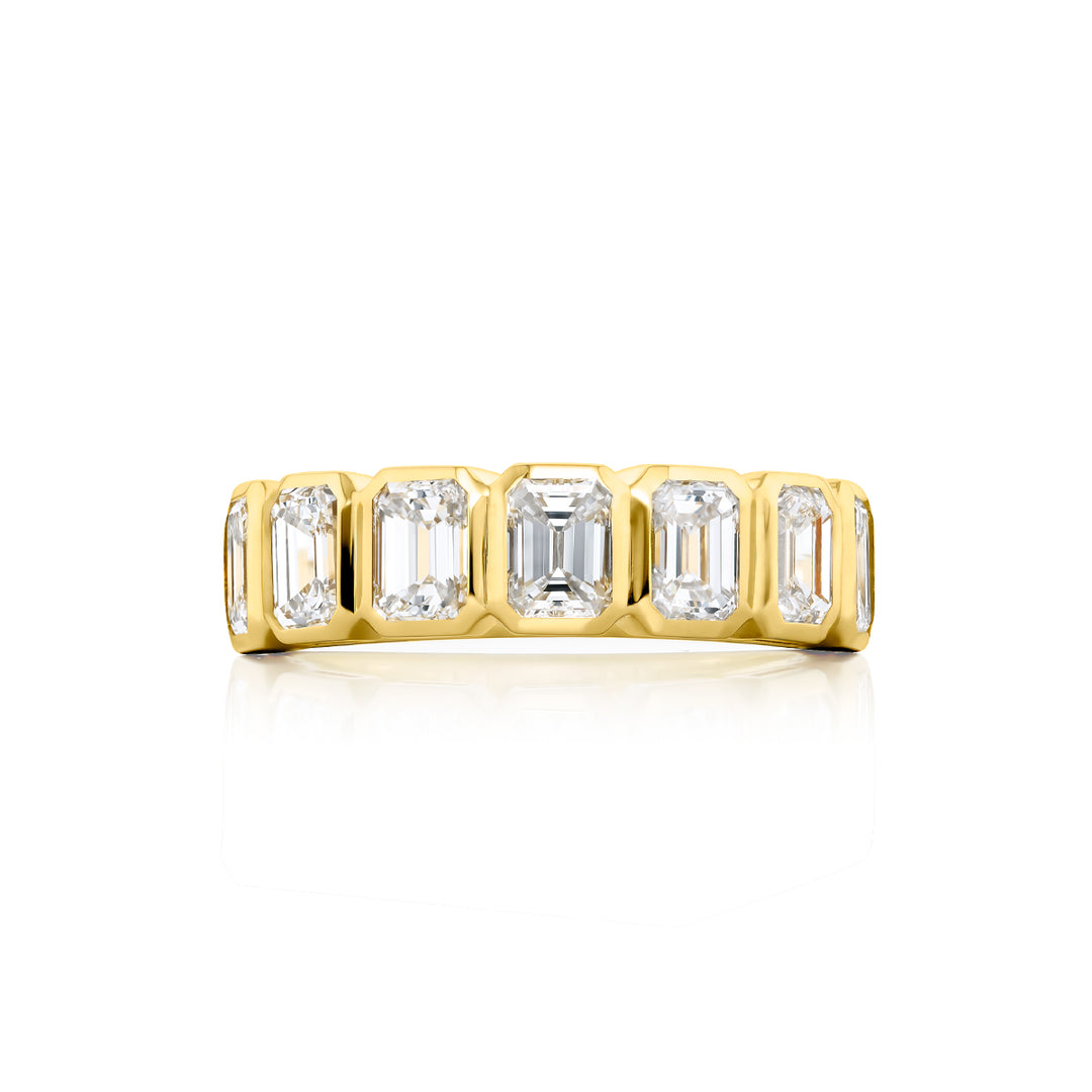 Elegance Elevated: Our stunning 2.52 ctw. Bezel Diamond Band. These seven beautiful emerald-cut diamonds are handcrafted in 18KY gold.