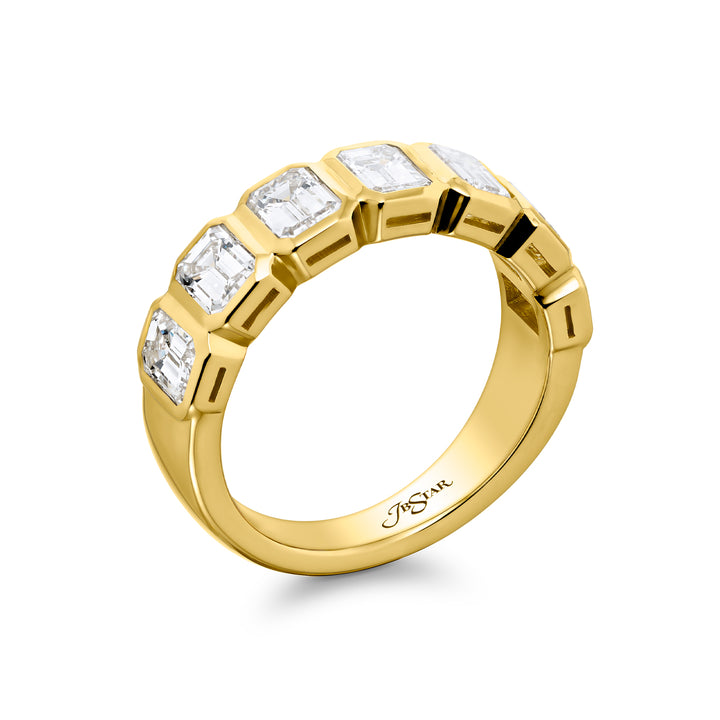 Elegance Elevated: Our stunning 2.52 ctw. Bezel Diamond Band. These seven beautiful emerald-cut diamonds are handcrafted in 18KY gold.