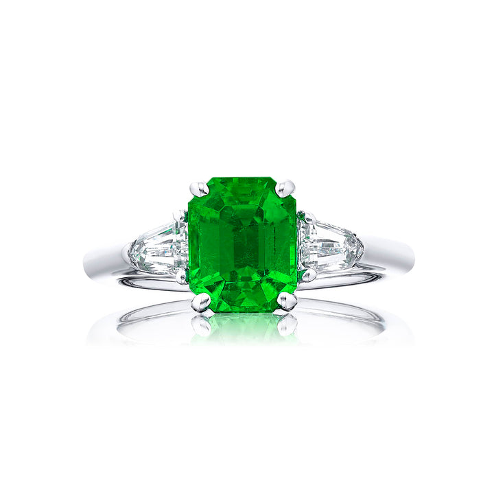 Breathtaking Radiance: Our elegant 2.04 ct. certified Emerald Ring. This beautiful vivid emerald-cut emerald flanked by bullet diamonds is handcrafted in pure platinum.