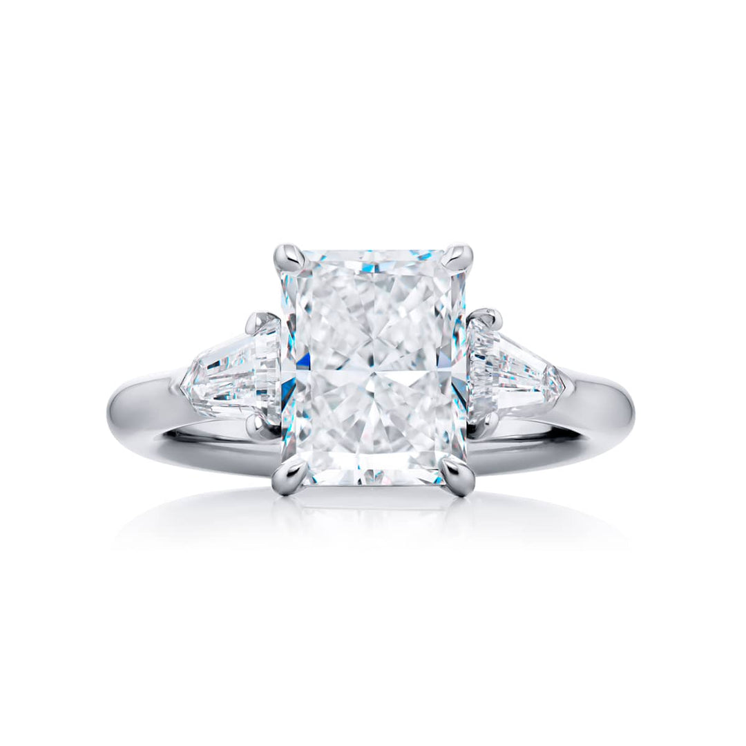 Dazzling Brilliance: Our timeless 3.05 ct. GIA certified Diamond Ring. This gorgeous radiant-cut diamond flanked by bullet diamonds is handcrafted in pure platinum.