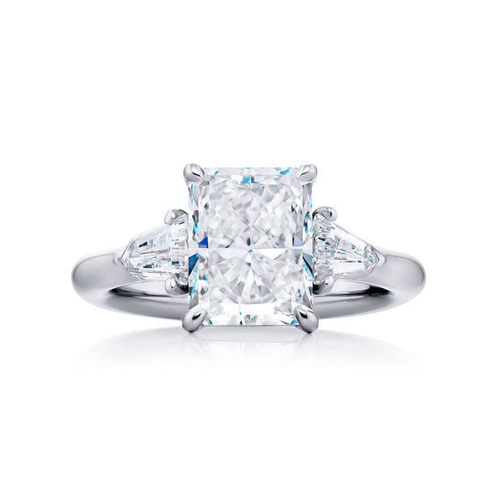 Dazzling Brilliance: Our timeless 3.05 ct. GIA certified Diamond Ring. This gorgeous radiant-cut diamond flanked by bullet diamonds is handcrafted in pure platinum.