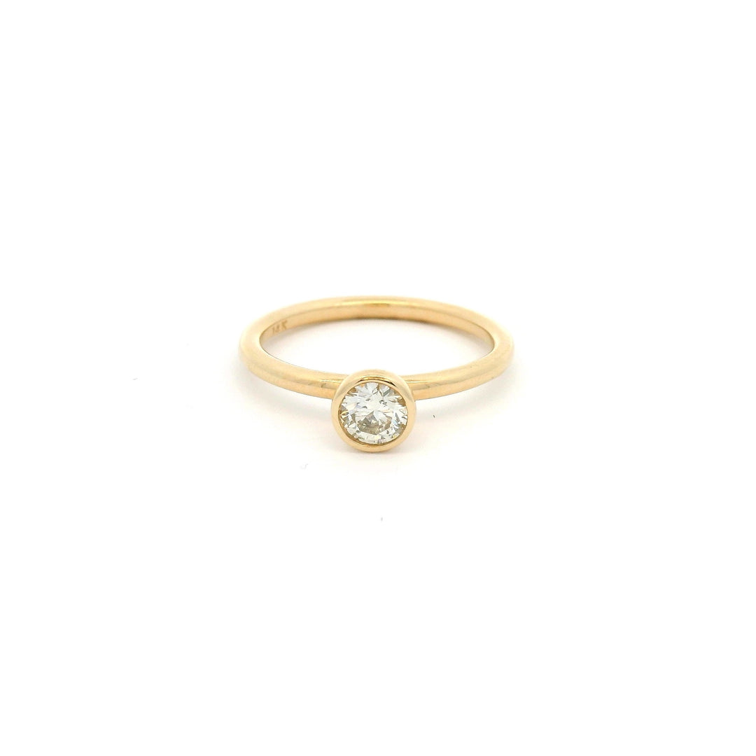 14k Yellow gold ring with a small round bezel set diamond