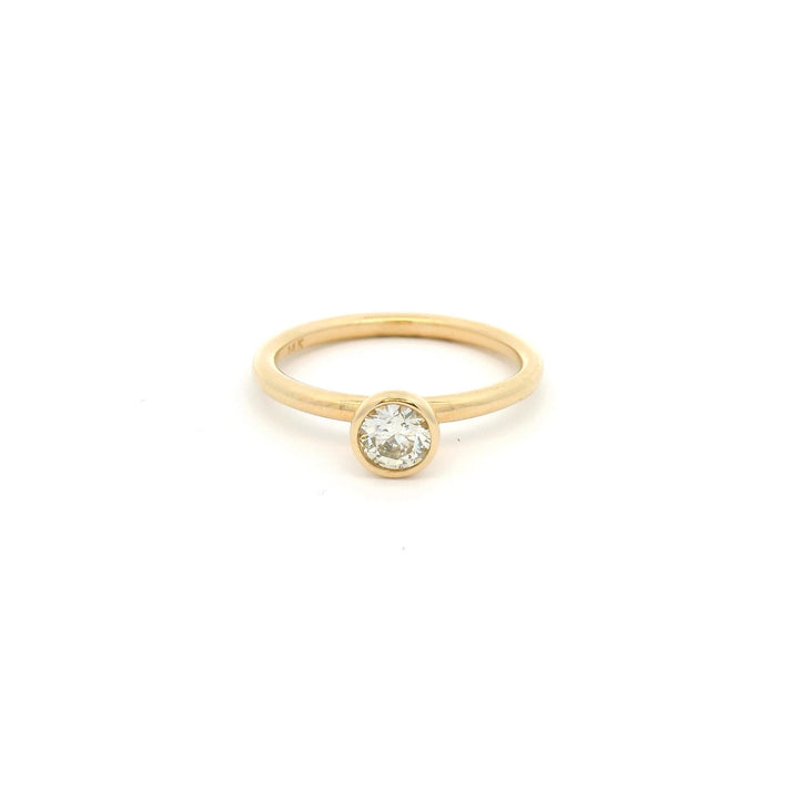 14k Yellow gold ring with a small round bezel set diamond
