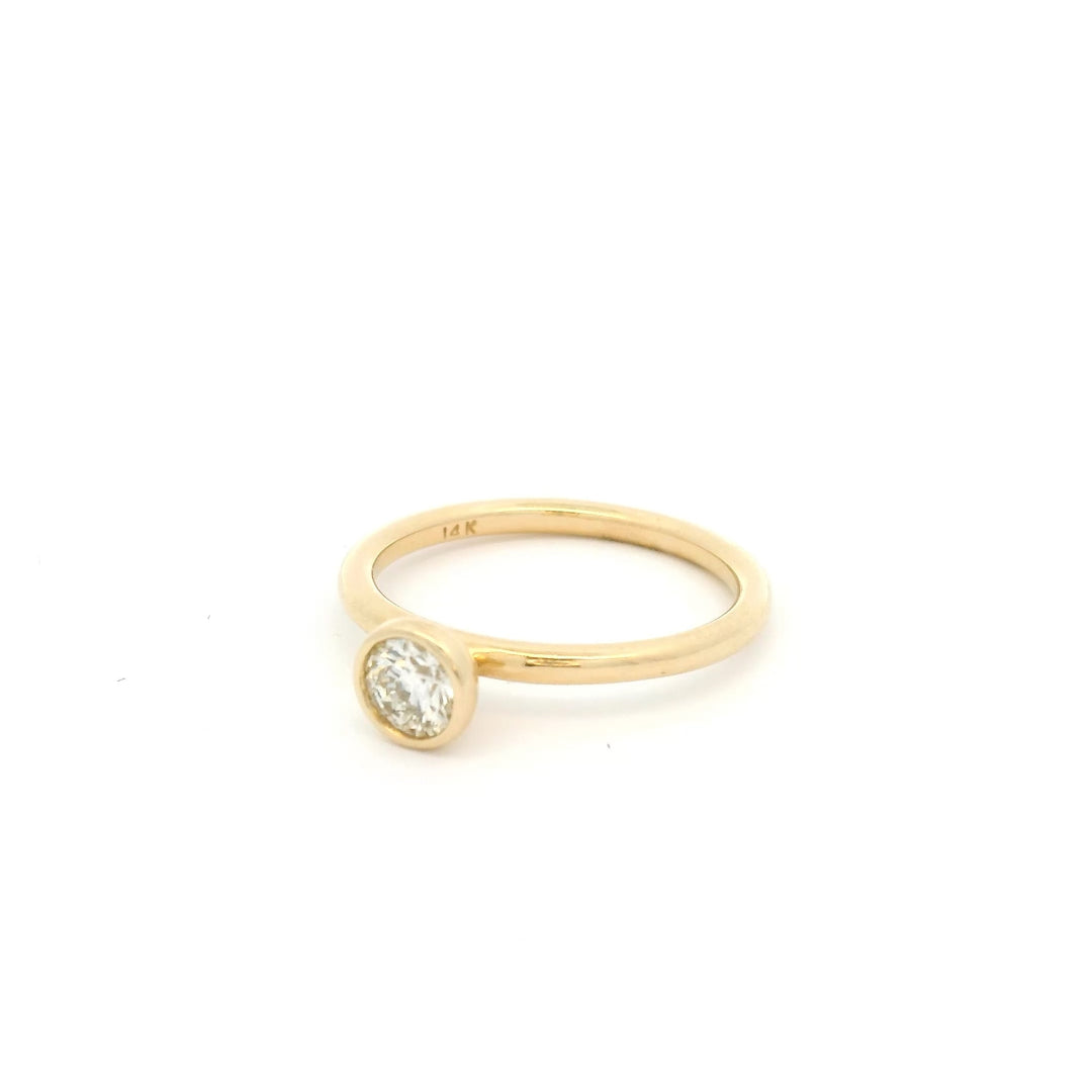 14k Yellow gold ring with a small round bezel set diamond