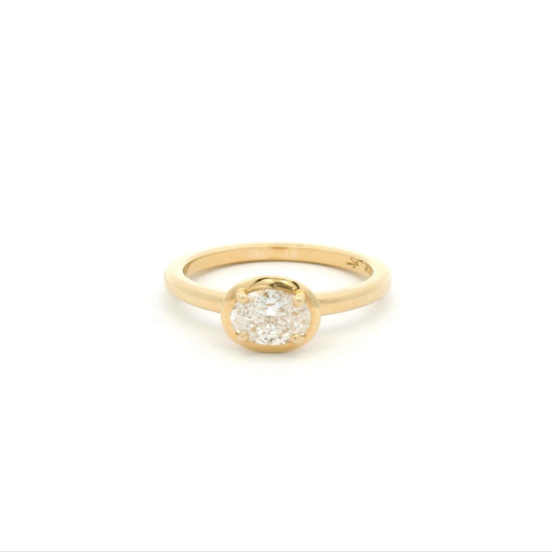 Bezel prong gold ring with oval diamond