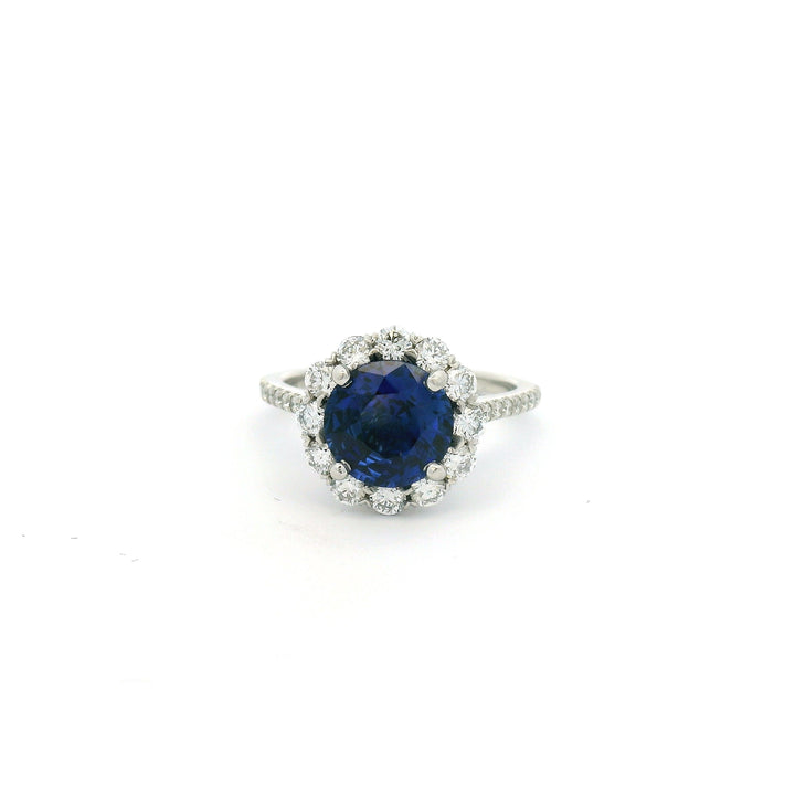 Platinum ring with a blue Sapphire and diamond halo