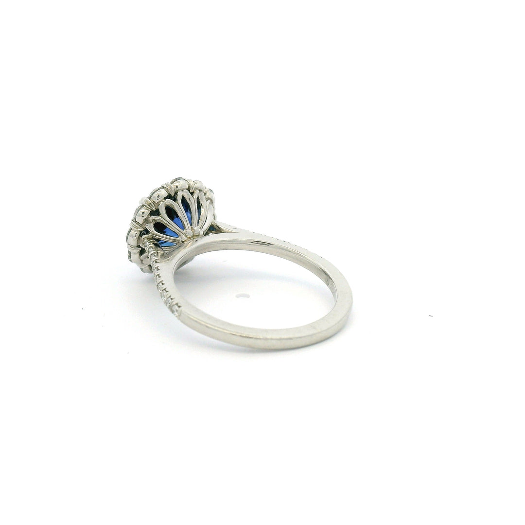 Platinum ring with a blue Sapphire and diamond halo