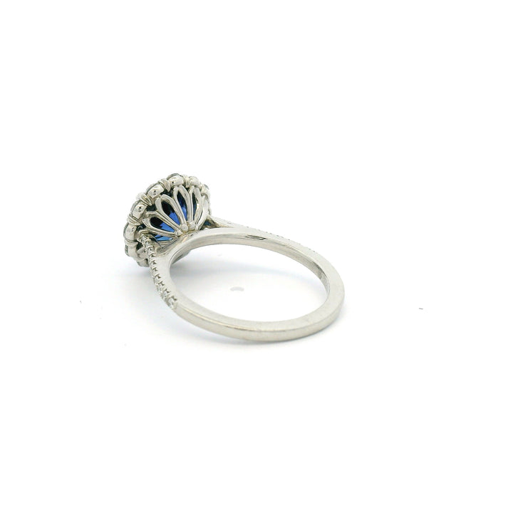 Platinum ring with a blue Sapphire and diamond halo