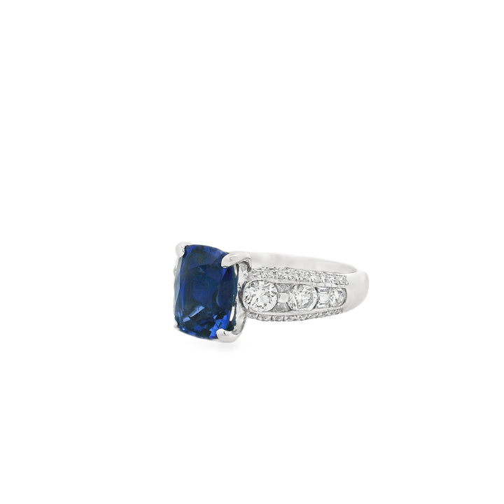 Platinum ring with a center cushion Sapphire and diamond pave sides