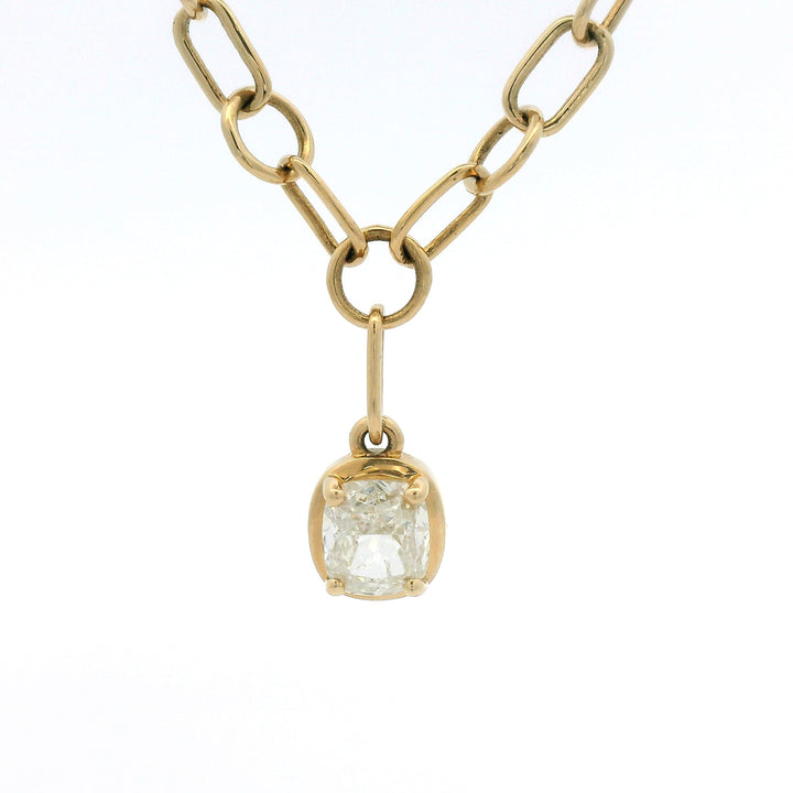 Yellow gold link chain with bezel set cushion