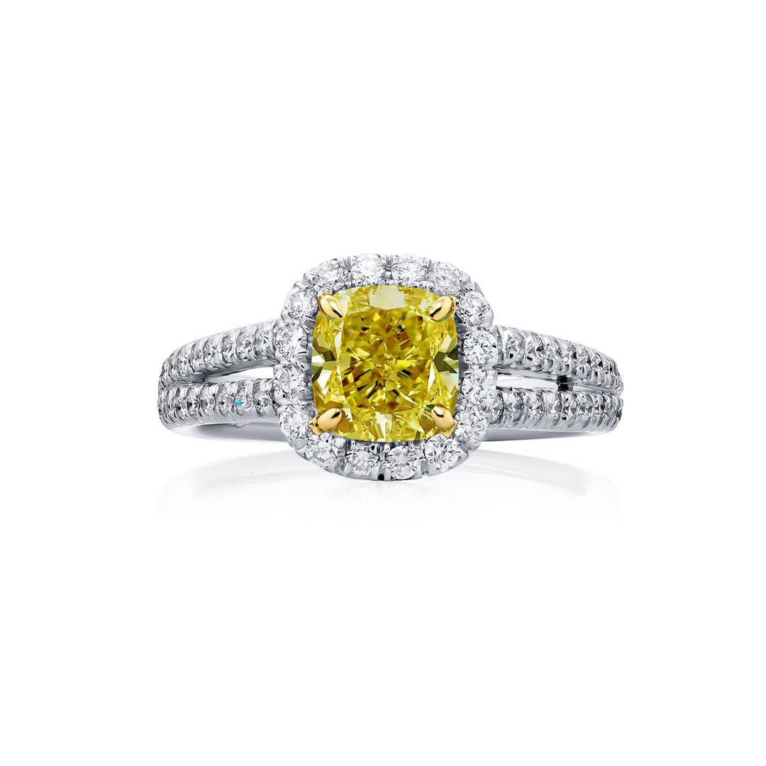 Dazzling Brilliance: Our beautiful 1.19 ct. GIA certified Fancy Yellow Diamond Ring. This cushion-cut fancy yellow diamond accompanied by round diamonds is handcrafted in pure platinum and 18KY gold.