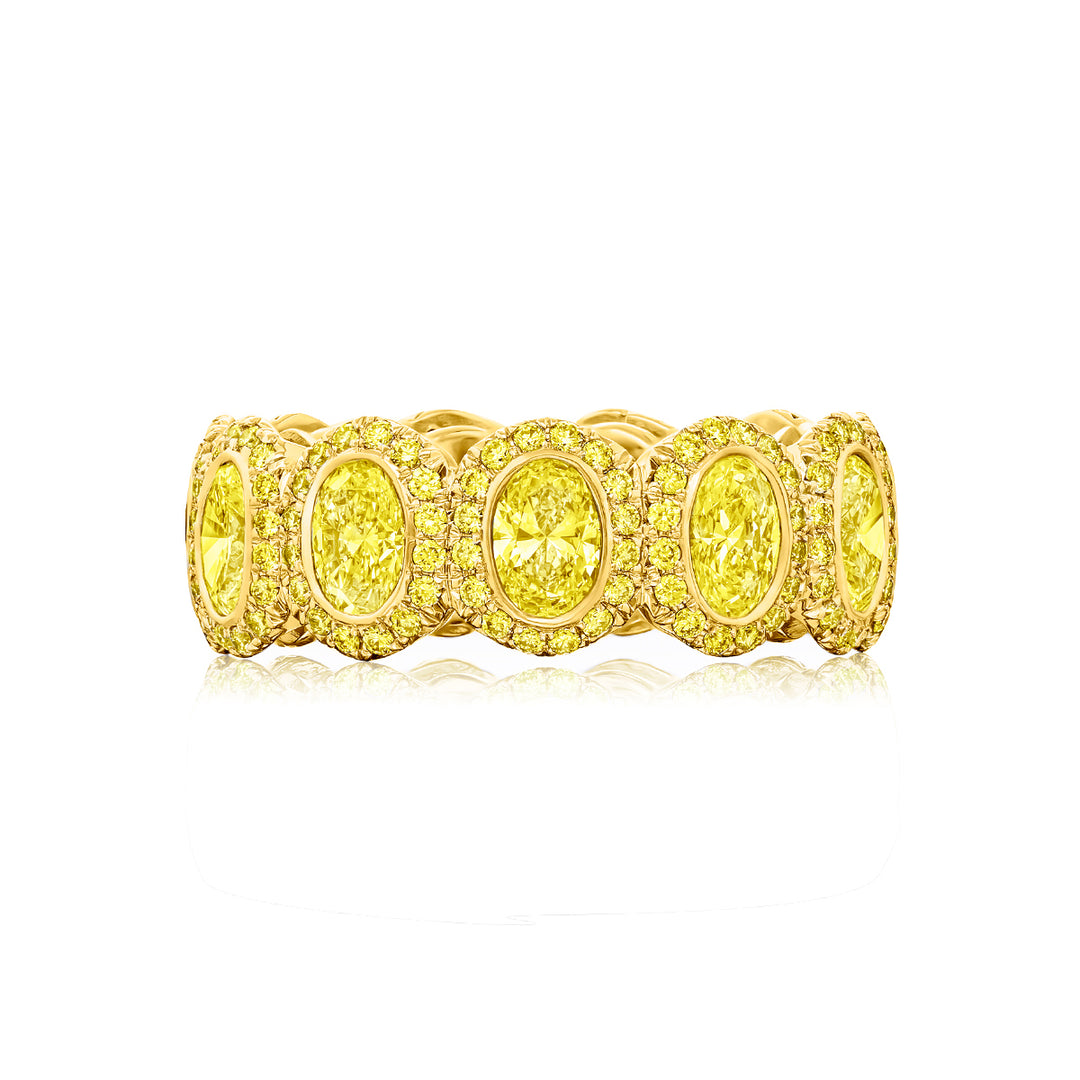 Alluring Eternity: Our signature 3.20 ctw.  Bezel Fancy Yellow Diamond Band. These gorgeous oval fancy yellow diamonds blended with round diamonds are handcrafted in 18KY gold.