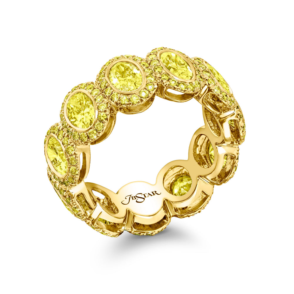 Alluring Eternity: Our signature 3.20 ctw.  Bezel Fancy Yellow Diamond Band. These gorgeous oval fancy yellow diamonds blended with round diamonds are handcrafted in 18KY gold.