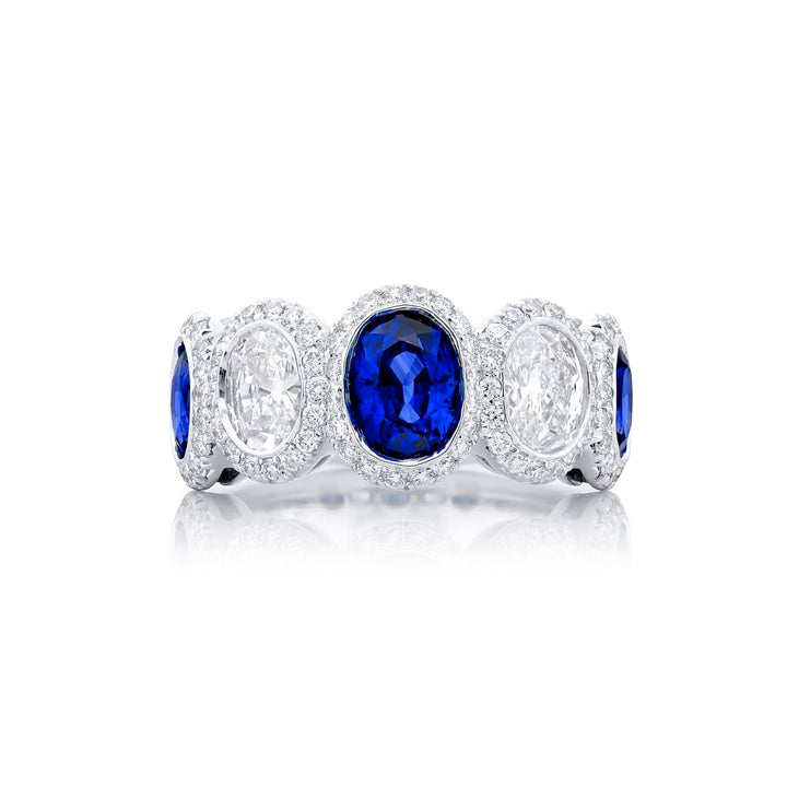 Elegance Elevated: Our signature Bezel Sapphire Band. These gorgeous oval sapphires and diamonds cradled in micro pave diamonds are handcrafted in pure platinum.