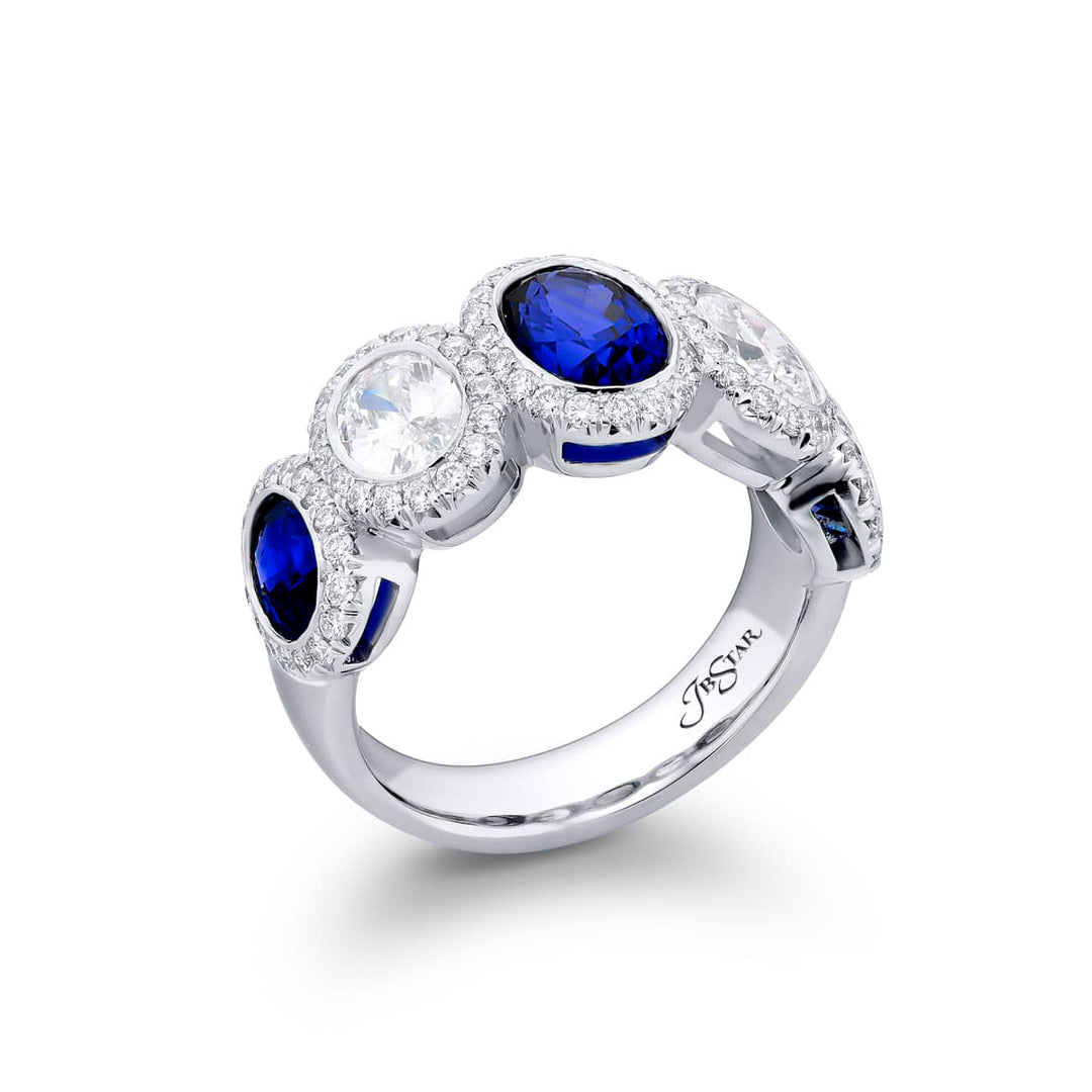 Elegance Elevated: Our signature Bezel Sapphire Band. These gorgeous oval sapphires and diamonds cradled in micro pave diamonds are handcrafted in pure platinum.