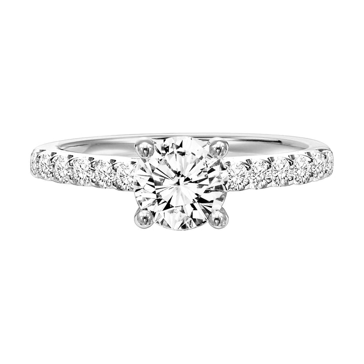 Round prong set diamonds grace the band of this engagement ring featuring a brilliant round diamond center stone for a timeless yet class look.  Center Stone is not included.