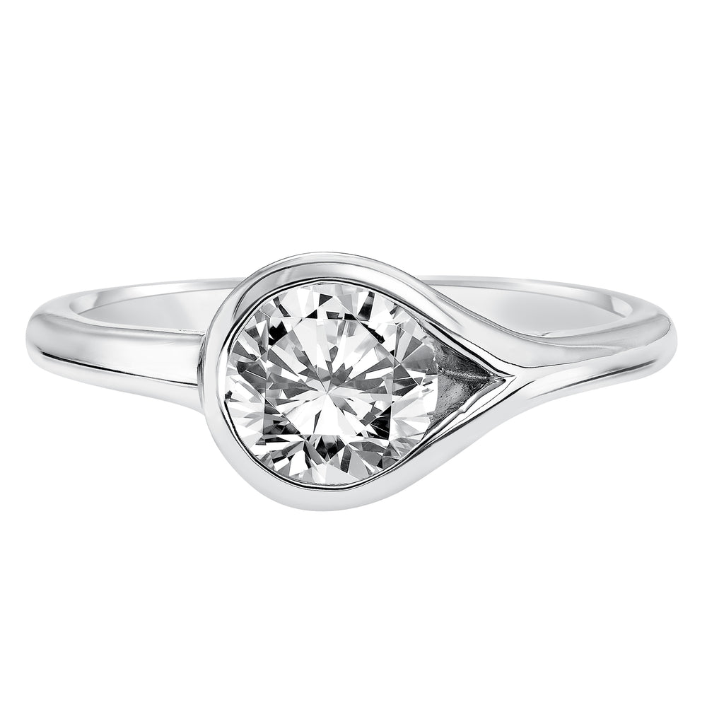 Chic and modern, this engagement ring is set beautifully in a high polished bezel set and bypass designed band.  Center Stone is not included.