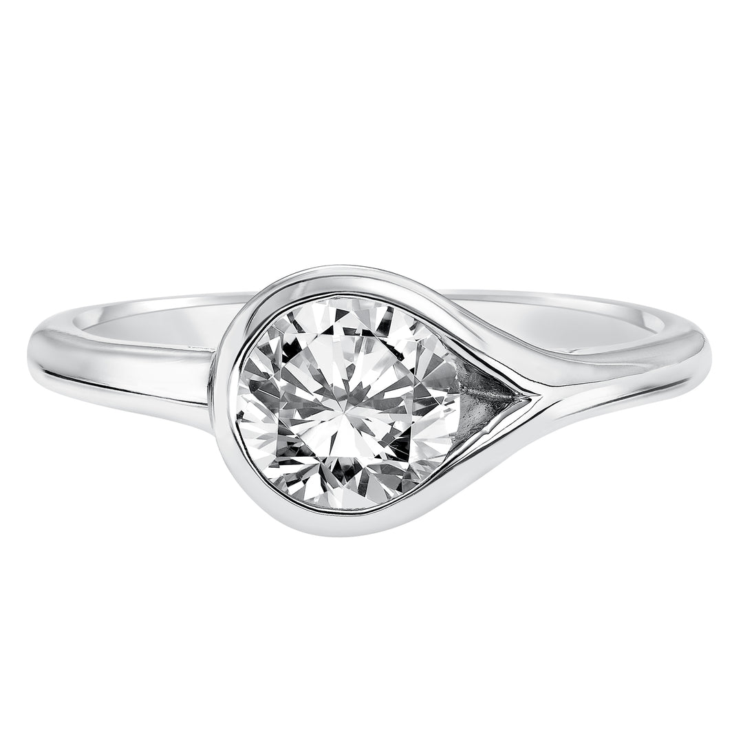 Chic and modern, this engagement ring is set beautifully in a high polished bezel set and bypass designed band.  Center Stone is not included.