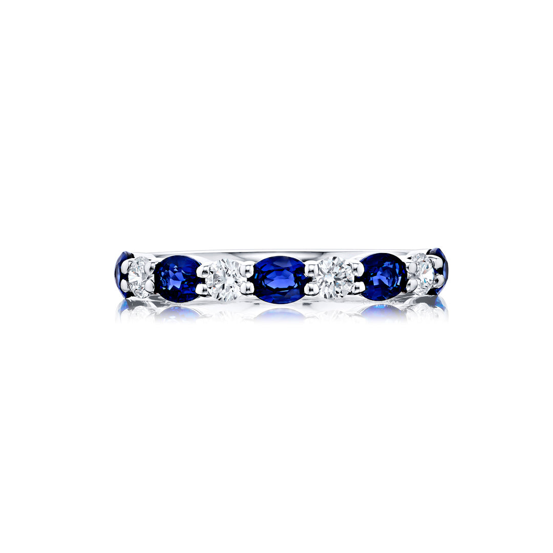 Elegance Elevated: Our classic single row East-West Sapphire Band. These stunning oval sapphires accompany round diamonds and are handcrafted in pure platinum.