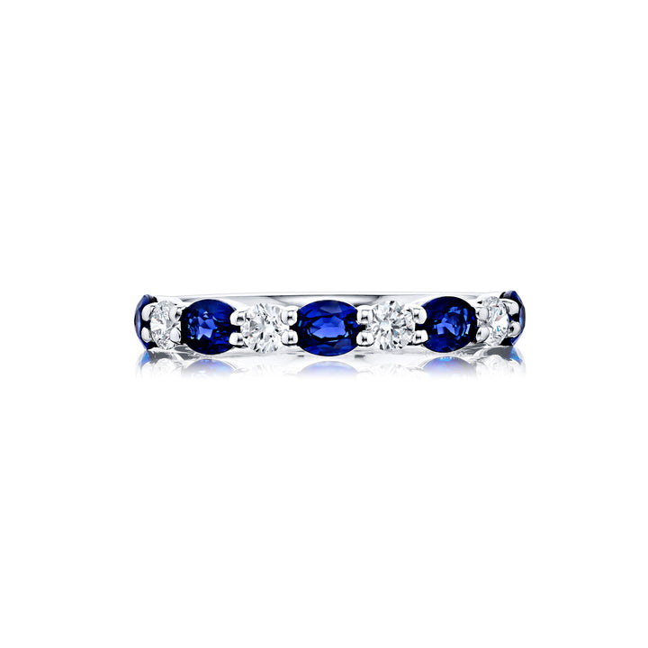 Elegance Elevated: Our classic single row East-West Sapphire Band. These stunning oval sapphires accompany round diamonds and are handcrafted in pure platinum.