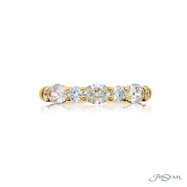 Elegance Elevated: Our classic 1.11 ctw. East-West single row Diamond Band. These beautiful oval diamonds accompany round diamonds and are handcrafted in 18KY gold.