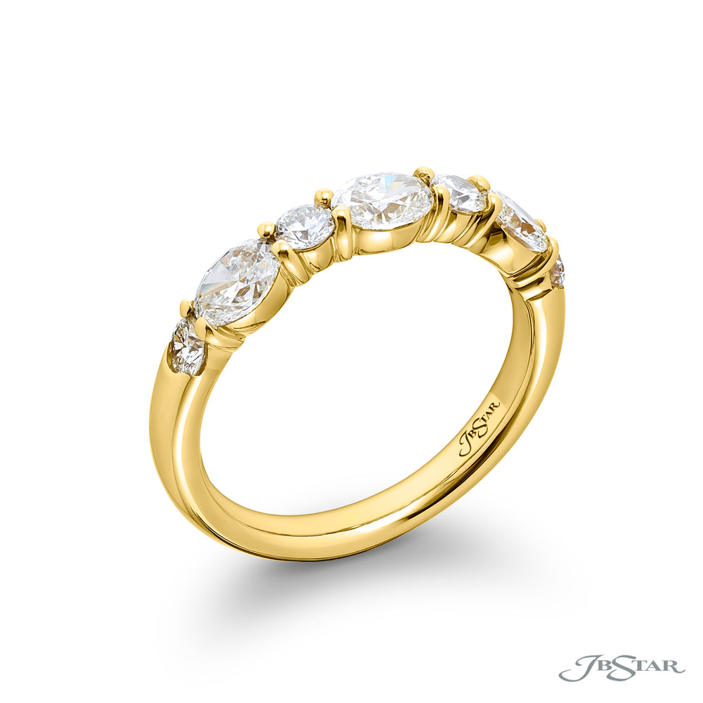 Elegance Elevated: Our classic 1.11 ctw. East-West single row Diamond Band. These beautiful oval diamonds accompany round diamonds and are handcrafted in 18KY gold.