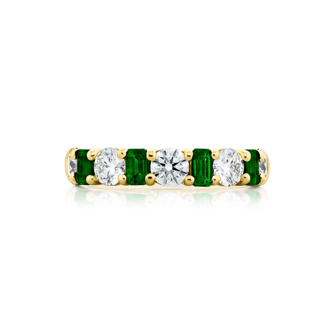 Elegance Elevated: Our signature Emerald and Diamond Band. These beautiful emerald-cut emeralds blended with dazzling round diamonds are handcrafted in 18KY gold.
