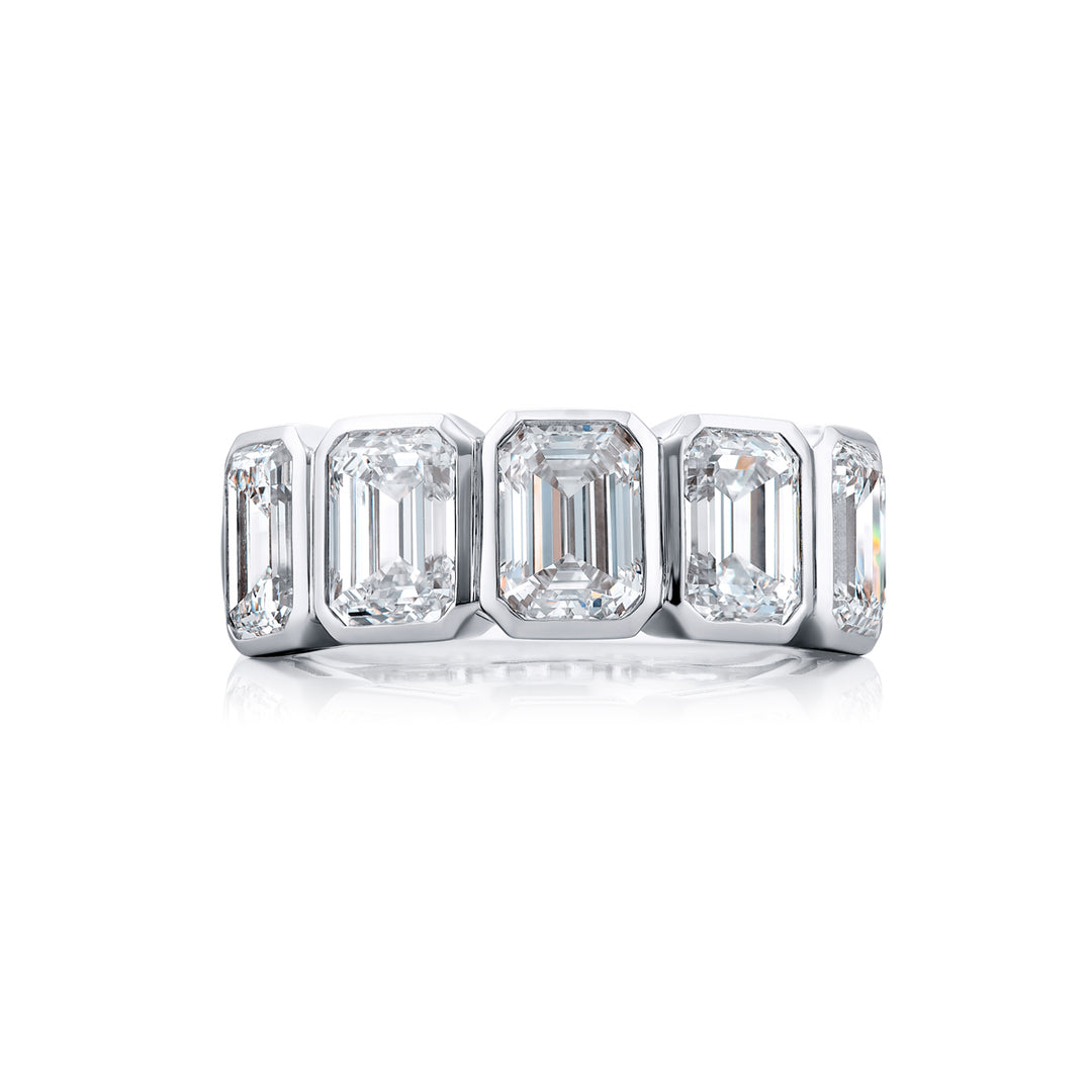 Elegance Elevated: Our stunning 5.11 ctw. GIA certified Bezel Diamond Band. These five beautiful emerald-cut diamonds are handcrafted in pure platinum.
