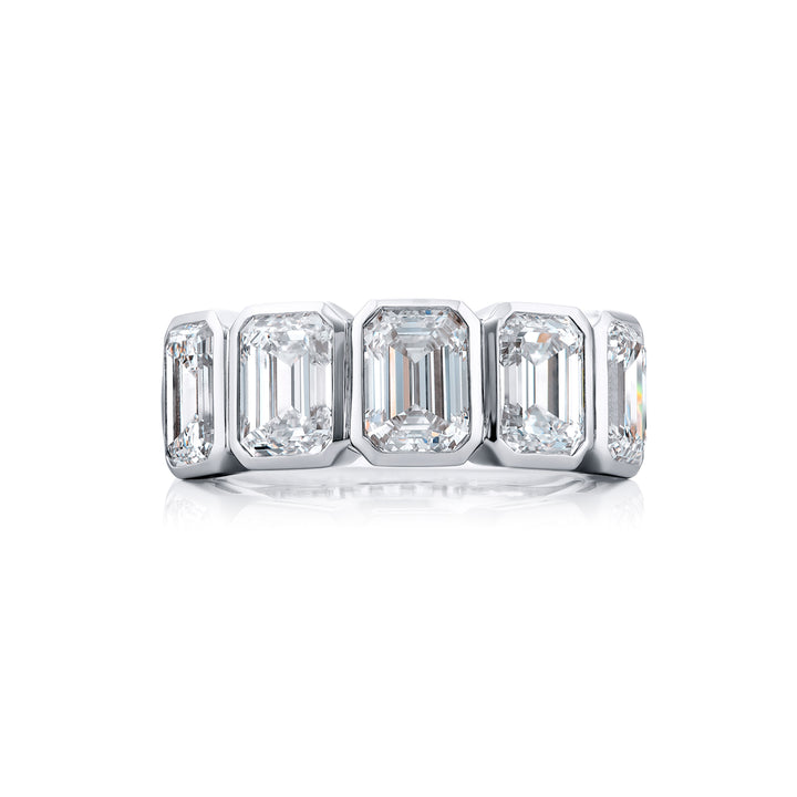 Elegance Elevated: Our stunning 5.11 ctw. GIA certified Bezel Diamond Band. These five beautiful emerald-cut diamonds are handcrafted in pure platinum.