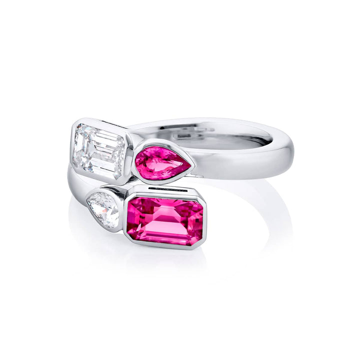 Breathtaking Radiance: Our unique GIA certified Bezel Twogether Pink Sapphire and Diamond Ring. This stunning emerald-cut diamond and pink sapphire accompanied by a shimmering pear-shaped diamond and pink sapphire are handcrafted in pure platinum.