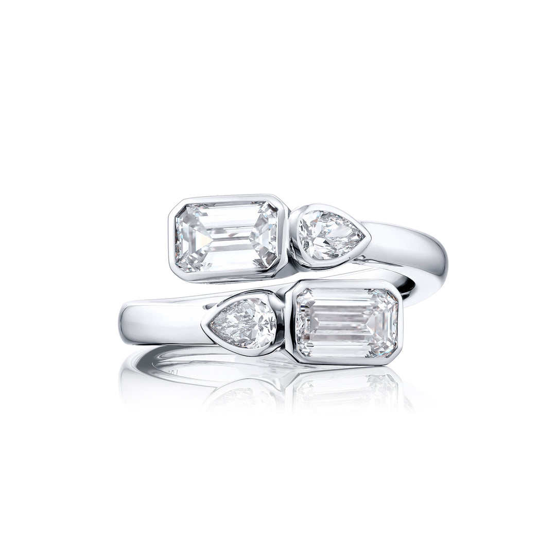Dazzling Brilliance: Our unique 1.63 ctw. GIA certified Bezel Twogether Diamond Ring. These stunning emerald-cut diamonds accompanied by dazzling pear-shaped diamonds are handcrafted in pure platinum.