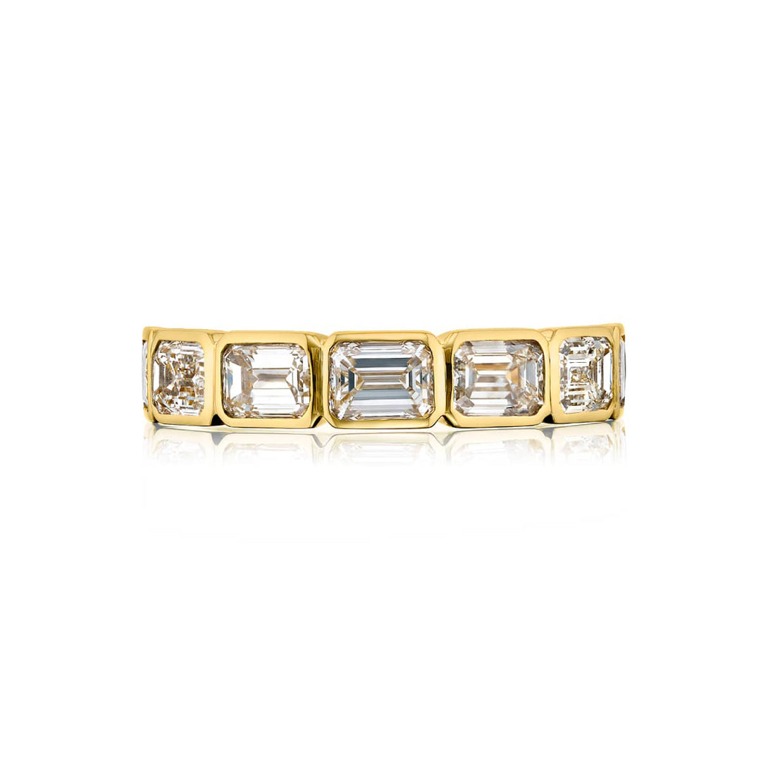 Elegance Elevated: Our classic single row East-West Diamond Band. These seven beautiful emerald-cut diamonds are handcrafted in 18KY gold.