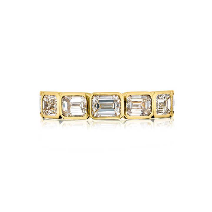 Elegance Elevated: Our classic single row East-West Diamond Band. These seven beautiful emerald-cut diamonds are handcrafted in 18KY gold.