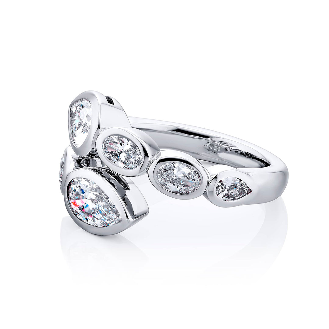 Dazzling Brilliance: Our unique 1.42 ctw. GIA certified Bezel Twogether Diamond Ring. These stunning pear-shaped diamonds accompanied by oval and pear-shaped diamonds are handcrafted in pure platinum.