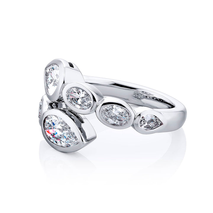 Dazzling Brilliance: Our unique 1.42 ctw. GIA certified Bezel Twogether Diamond Ring. These stunning pear-shaped diamonds accompanied by oval and pear-shaped diamonds are handcrafted in pure platinum.