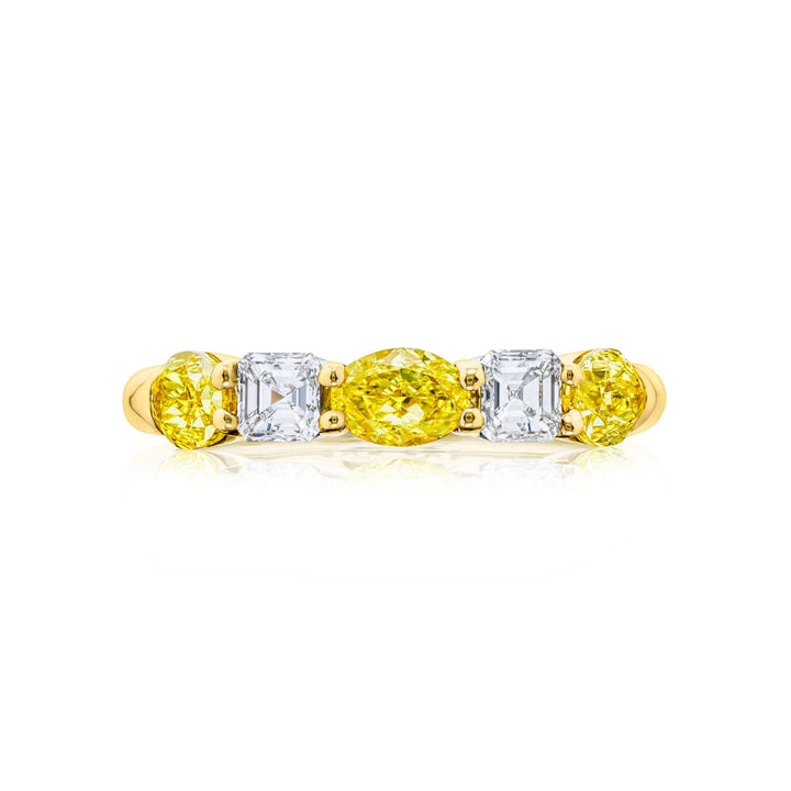 Elegance Elevated: Our classic single row East-West Fancy Yellow & White Diamond Band. These oval fancy yellow diamonds accompany square emerald-cut white diamonds and are handcrafted in 18KY gold.