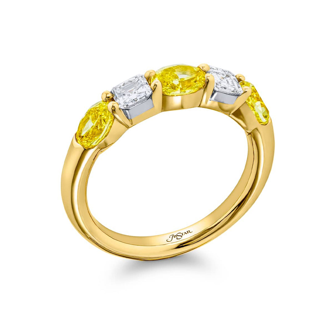 Elegance Elevated: Our classic single row East-West Fancy Yellow & White Diamond Band. These oval fancy yellow diamonds accompany square emerald-cut white diamonds and are handcrafted in 18KY gold.