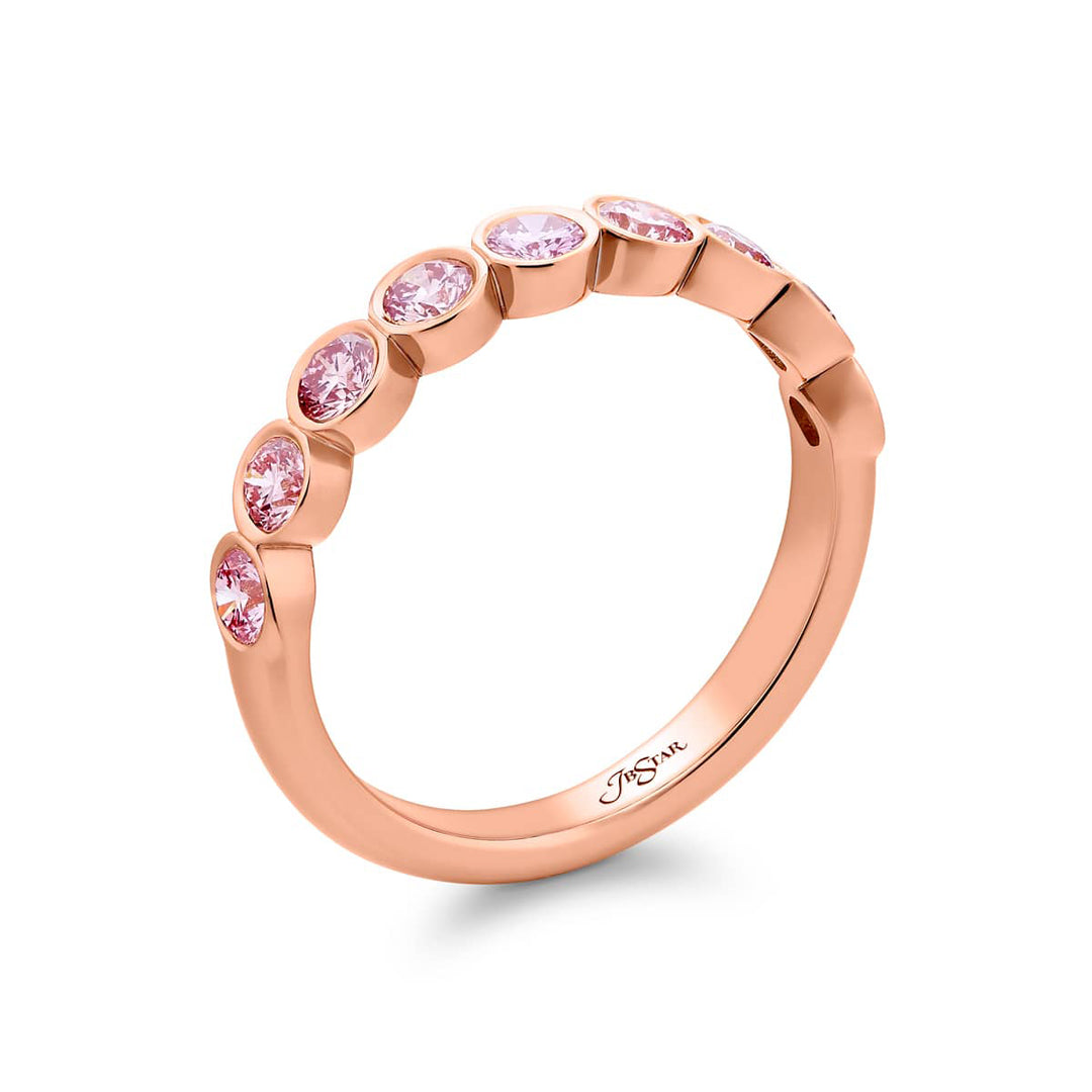 Elegance Elevated: Our stunning 0.95 ctw. East-West Bezel Pink Diamond Band. These nine beautiful round pink diamonds are handcrafted in 18K pink gold.