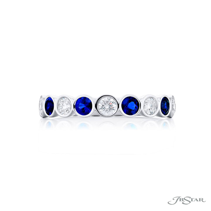 Elegance Elevated: Our stunning East-West Bezel Sapphire and Diamond Band. These beautiful round sapphires blended with round diamonds are handcrafted in pure platinum.