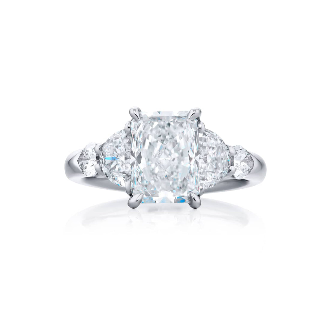 Dazzling Brilliance: Our timeless 2.50 ct. GIA certified Diamond Ring. This gorgeous radiant-cut diamond flanked by shield and half-moon diamonds is handcrafted in pure platinum.