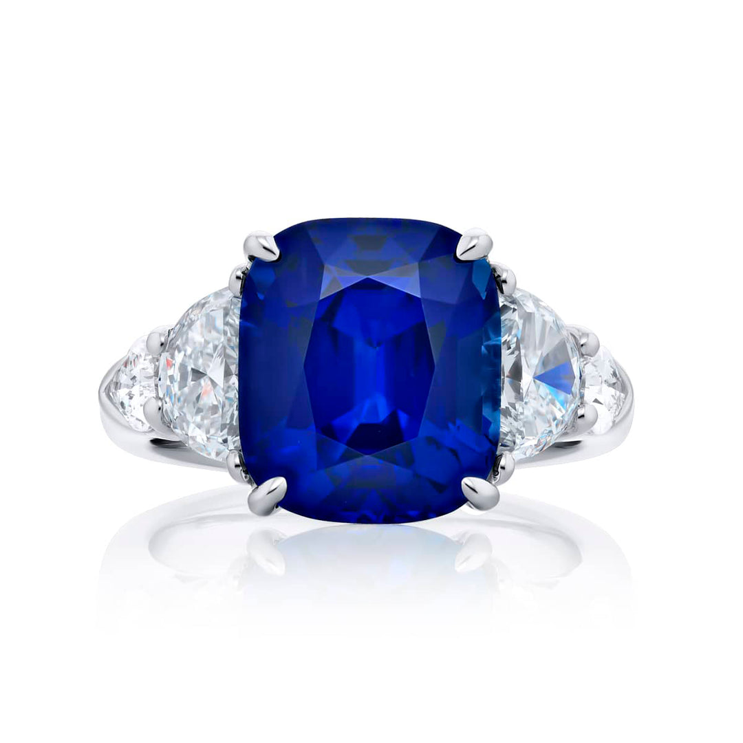 Breathtaking Radiance: Our stunning 7.04 ct. certified Sri Lankan Sapphire Ring. This beautiful cushion-cut sapphire crowned in dazzling shield and half-moon diamonds is handcrafted in pure platinum.